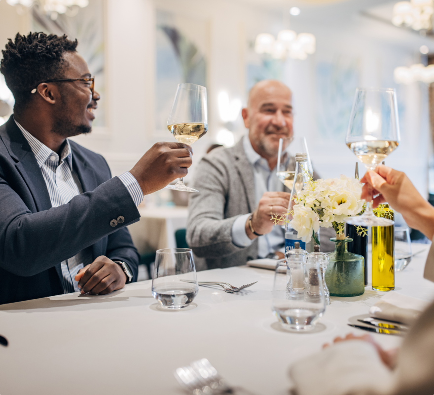 a group of people toasting at the marker