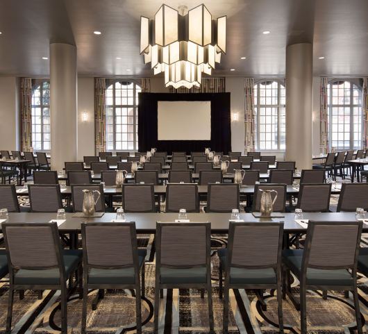 rows of tables and chairs in a meetin space at the marker