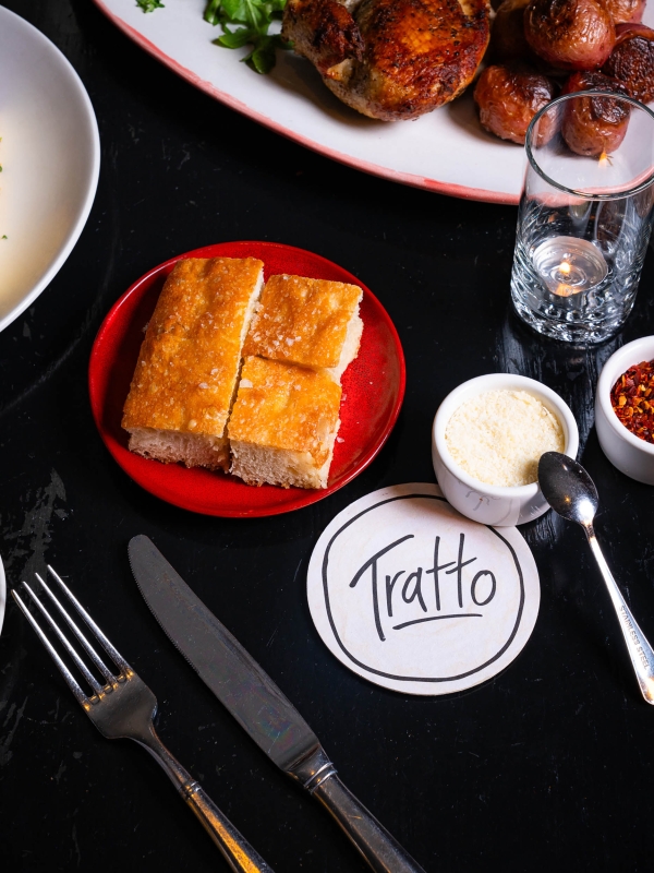 Close up of food on plates prepared by Tratto