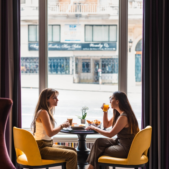 2 people enjoying lunch while sitting in front of a window at The Marker