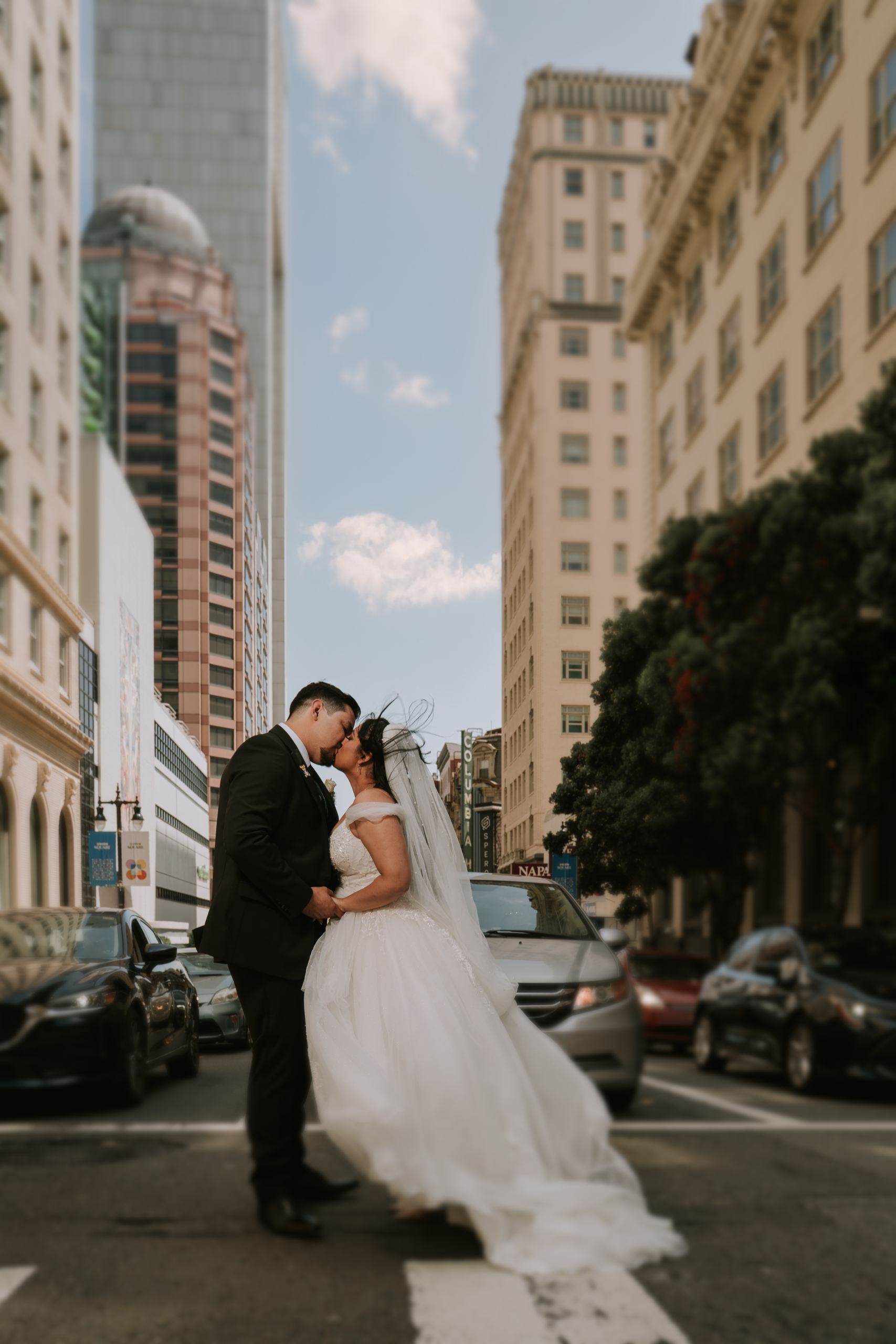 bride and groom in front of san francisco traffic